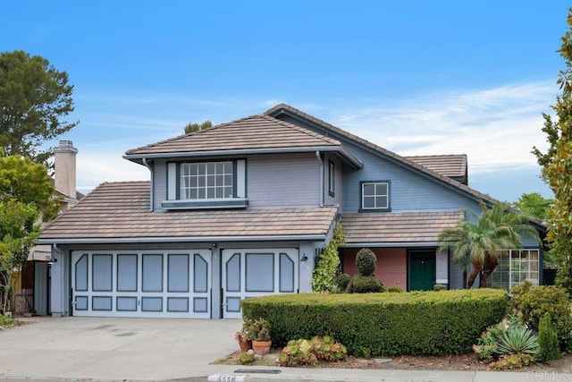 4556 Mariners Bay, Oceanside, CA 92057 - traditional home with concrete driveway, a chimney, and a tiled roof