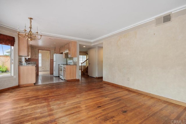 4556 Mariners Bay, Oceanside, CA 92057 - unfurnished living room with wood finished floors, healthy amount of natural light, a chandelier, and crown molding