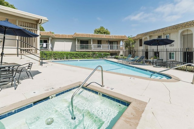 2340 Caringa Way Unit B, Carlsbad, CA 92009 - community pool featuring a patio area and a hot tub