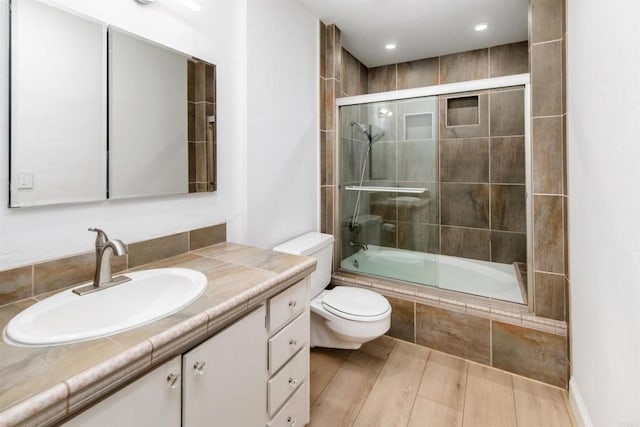 2340 Caringa Way Unit B, Carlsbad, CA 92009 - full bathroom with tiled shower / bath combo, vanity, and wood finished floors