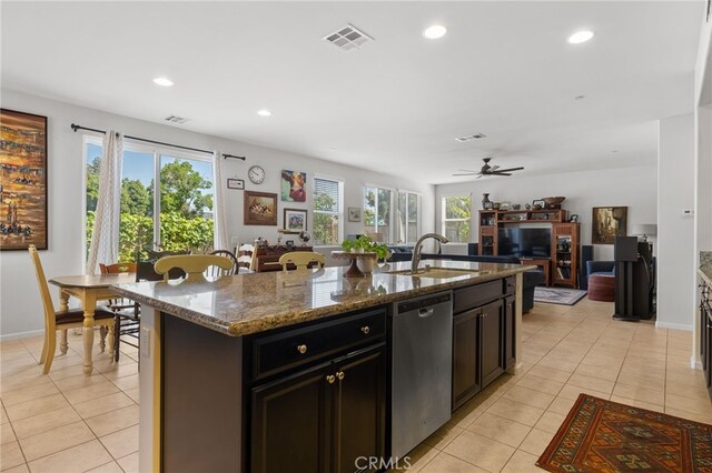12200 White Rapids Way, Bakersfield, CA 93311 - kitchen featuring stainless steel dishwasher, light tile patterned floors, plenty of natural light, dark stone countertops, and recessed lighting