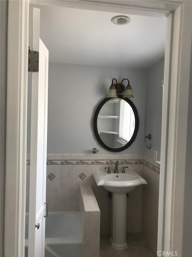 3666 Cedar Ave, Long Beach, CA 90807 - bathroom featuring a garden tub, tile walls, a wainscoted wall, and tile patterned flooring
