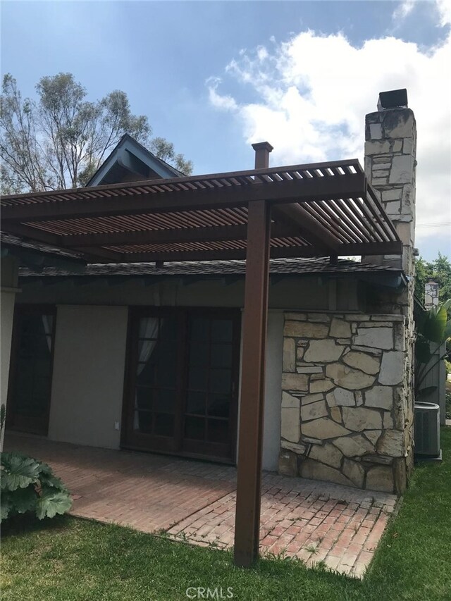3666 Cedar Ave, Long Beach, CA 90807 - rear view of house with stone siding, a chimney, and a pergola