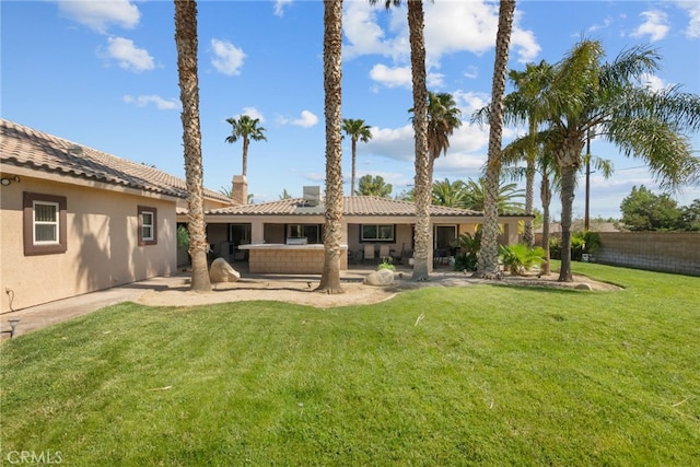 40139 15th St W, Palmdale, CA 93551 - rear view of property featuring stucco siding, a patio, a tile roof, and a chimney