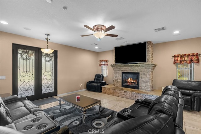 40139 15th St W, Palmdale, CA 93551 - living room featuring french doors, a ceiling fan, a stone fireplace, recessed lighting, and light tile patterned floors