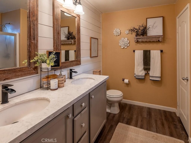 3031 E Lingard St, Lancaster, CA 93535 - bathroom with double vanity, wood finished floors, wooden walls, and a shower