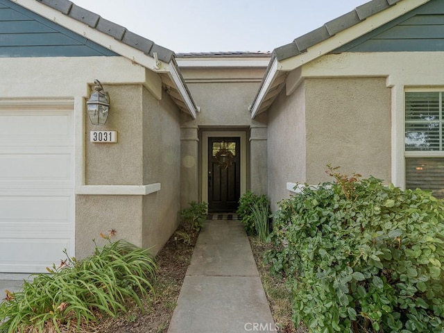 3031 E Lingard St, Lancaster, CA 93535 - entrance to property with a garage and stucco siding