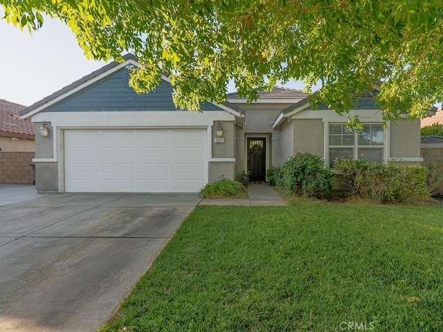 3031 E Lingard St, Lancaster, CA 93535 - view of front facade featuring a garage, stucco siding, concrete driveway, and a front yard