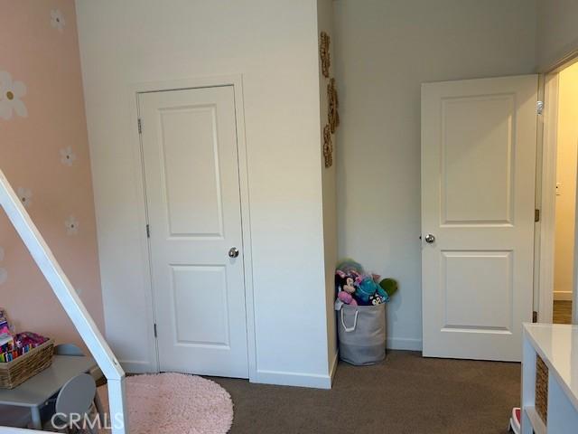 1658 Almondwood Dr, Orland, CA 95963 - bedroom with dark carpet and baseboards