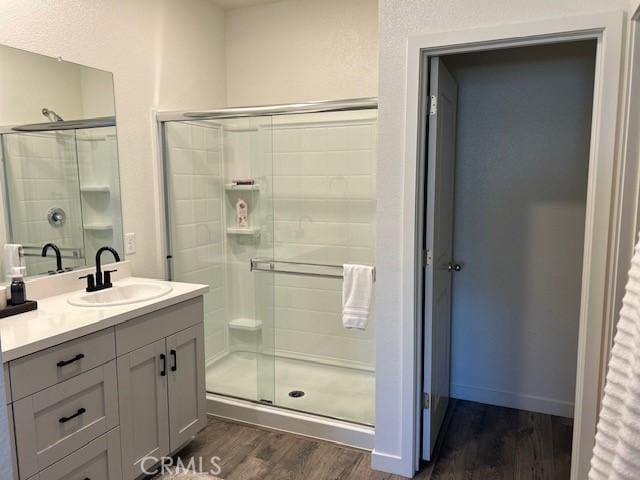 1658 Almondwood Dr, Orland, CA 95963 - full bathroom with wood finished floors, vanity, and a shower stall