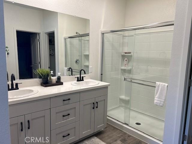 1658 Almondwood Dr, Orland, CA 95963 - full bath with double vanity, a shower stall, and wood finished floors