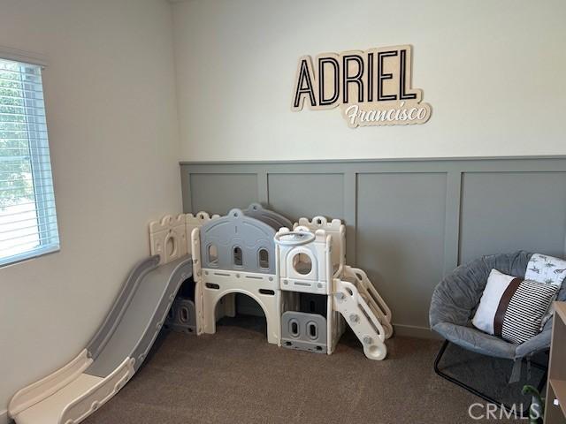 1658 Almondwood Dr, Orland, CA 95963 - carpeted bedroom featuring a decorative wall and wainscoting