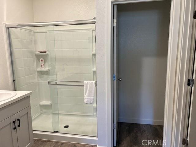 1658 Almondwood Dr, Orland, CA 95963 - full bathroom featuring wood finished floors, a shower stall, and vanity