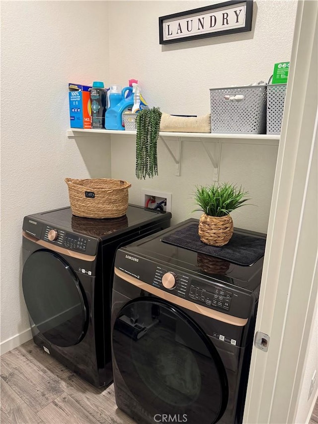 1658 Almondwood Dr, Orland, CA 95963 - washroom featuring separate washer and dryer and wood finished floors