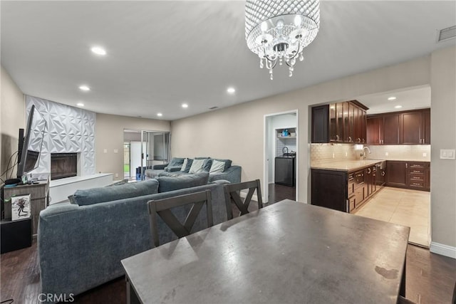 9548 Orizaba Ave, Downey, CA 90240 - living area with recessed lighting, a premium fireplace, a chandelier, and light wood finished floors