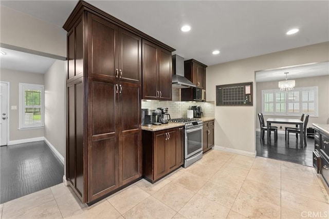 9548 Orizaba Ave, Downey, CA 90240 - kitchen with gas range, wall chimney range hood, backsplash, a chandelier, and dark brown cabinetry