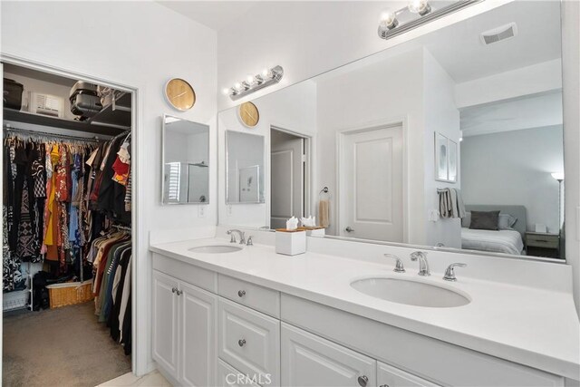 13131 Park Pl Unit 102, Hawthorne, CA 90250 - bathroom featuring double vanity, ensuite bathroom, and a spacious closet