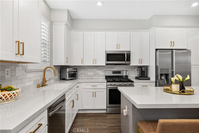 13131 Park Pl Unit 102, Hawthorne, CA 90250 - kitchen featuring appliances with stainless steel finishes, light countertops, white cabinetry, recessed lighting, and decorative backsplash