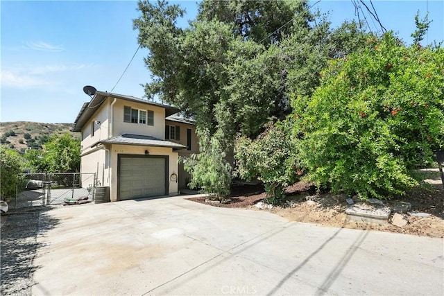30156 Lexington Dr, Castaic, CA 91384 - view of front facade featuring stucco siding, an attached garage, concrete driveway, and a gate