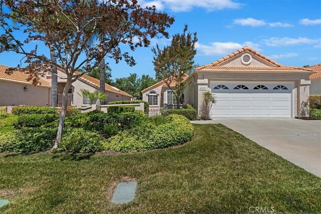 40209 Corte Peralta, Murrieta, CA 92562 - view of front of property with driveway, a garage, a front yard, a tile roof, and stucco siding