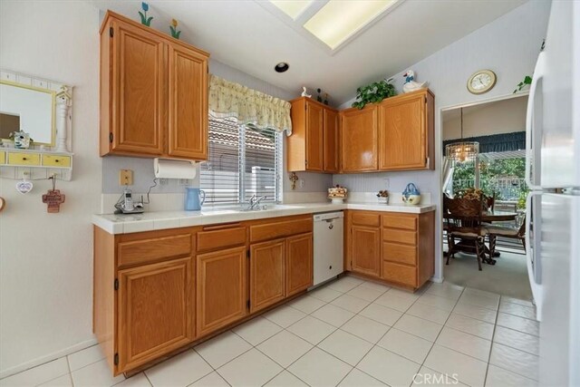 40209 Corte Peralta, Murrieta, CA 92562 - kitchen with white appliances, plenty of natural light, vaulted ceiling, light countertops, and light tile patterned floors