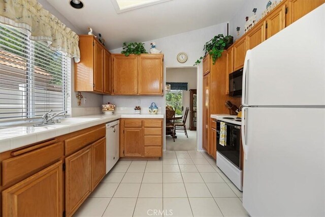 40209 Corte Peralta, Murrieta, CA 92562 - kitchen featuring white appliances, lofted ceiling, and light tile patterned floors