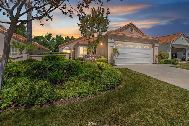 40209 Corte Peralta, Murrieta, CA 92562 - mediterranean / spanish home with concrete driveway, stucco siding, a tile roof, a garage, and a lawn