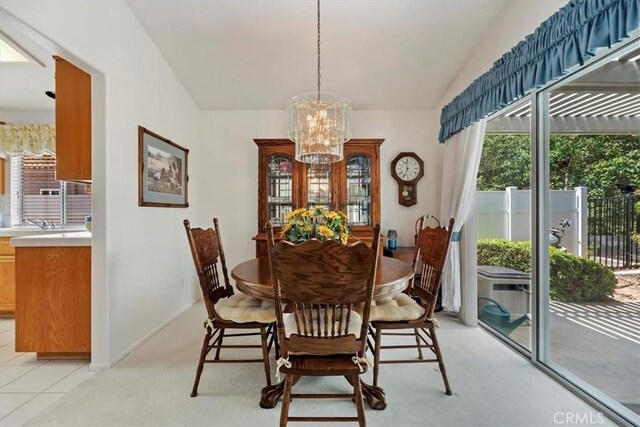40209 Corte Peralta, Murrieta, CA 92562 - dining area with a chandelier, healthy amount of natural light, vaulted ceiling, and light carpet