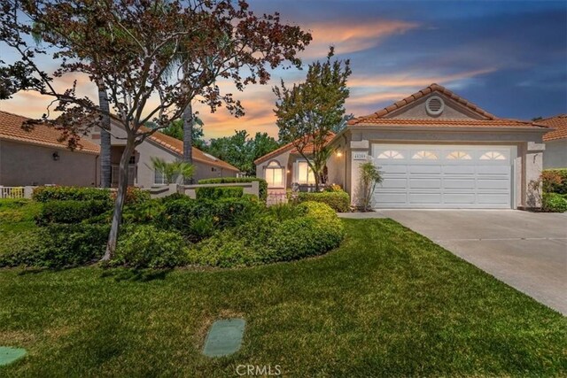 40209 Corte Peralta, Murrieta, CA 92562 - mediterranean / spanish-style house with concrete driveway, a tile roof, a front yard, and an attached garage