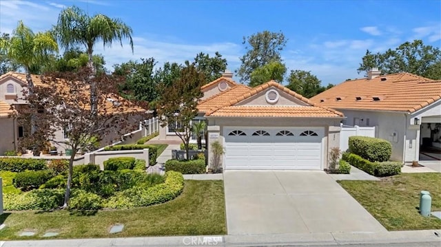40209 Corte Peralta, Murrieta, CA 92562 - view of front of home featuring a tiled roof, an attached garage, driveway, and stucco siding