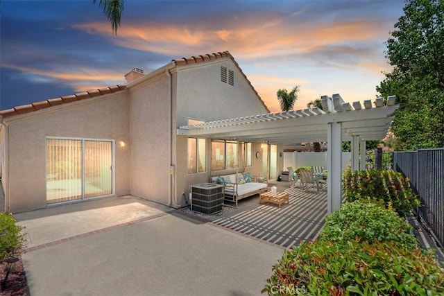 40209 Corte Peralta, Murrieta, CA 92562 - back of property at dusk featuring a pergola, a patio area, stucco siding, and outdoor lounge area