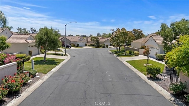40209 Corte Peralta, Murrieta, CA 92562 - view of asphalt street featuring a residential view, street lighting, and curbs