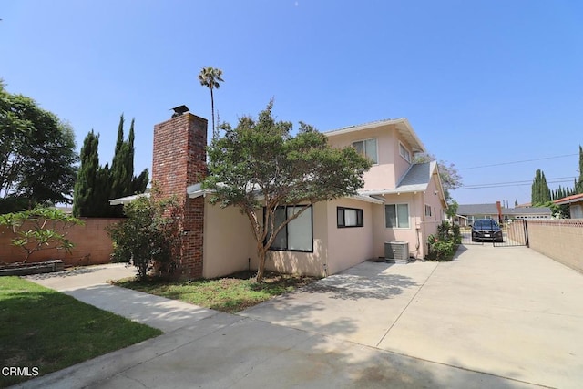5026 Doreen Ave, Temple City, CA 91780 - rear view of property featuring stucco siding, driveway, and a chimney