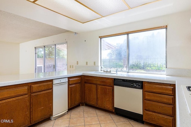 2026 Thomas Pl, West Covina, CA 91792 - kitchen with dishwasher, brown cabinets, light countertops, and light tile patterned floors