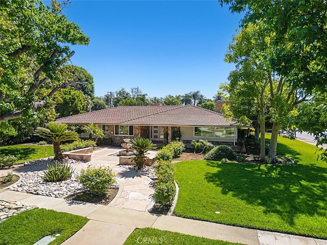 1604 N Laurel Ave, Upland, CA 91784 - single story home featuring a front yard, a tile roof, and stone siding