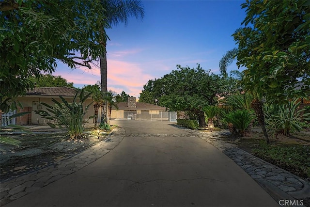 1604 N Laurel Ave, Upland, CA 91784 - view of front of home with driveway, a gate, and stucco siding