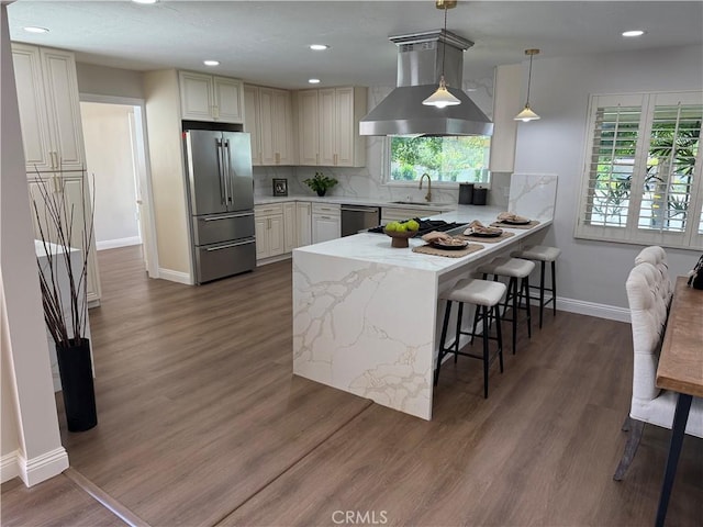 1604 N Laurel Ave, Upland, CA 91784 - kitchen with stainless steel appliances, wall chimney exhaust hood, a peninsula, healthy amount of natural light, and recessed lighting