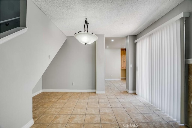 37940 42nd St E Unit 129, Palmdale, CA 93552 - unfurnished dining area with a textured ceiling and light tile patterned floors