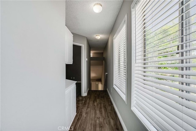 37940 42nd St E Unit 129, Palmdale, CA 93552 - corridor featuring a textured ceiling, dark wood-type flooring, and healthy amount of natural light