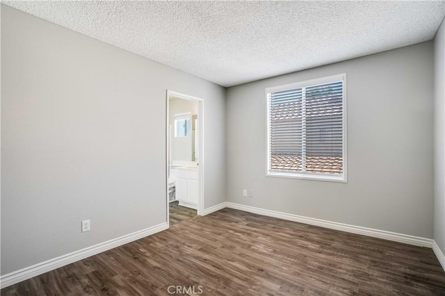37940 42nd St E Unit 129, Palmdale, CA 93552 - unfurnished room with dark wood finished floors and a textured ceiling