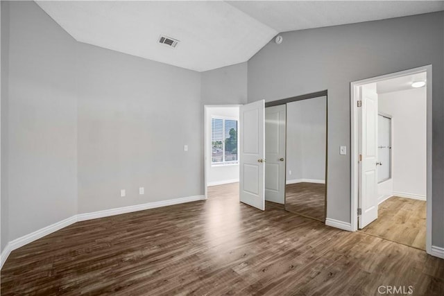 37940 42nd St E Unit 129, Palmdale, CA 93552 - unfurnished bedroom with lofted ceiling, wood finished floors, and a closet