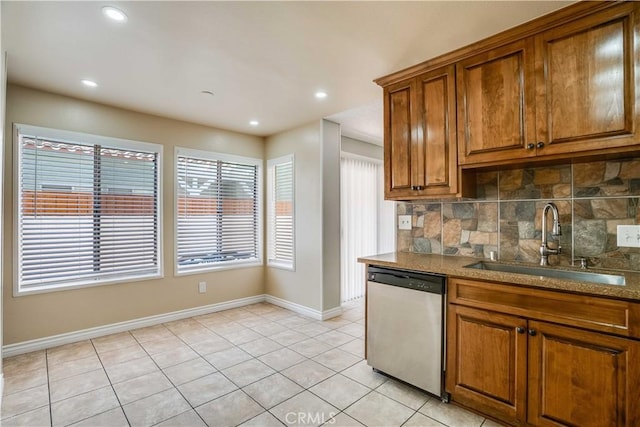 37940 42nd St E Unit 129, Palmdale, CA 93552 - kitchen featuring stainless steel dishwasher, brown cabinetry, tasteful backsplash, light tile patterned floors, and recessed lighting