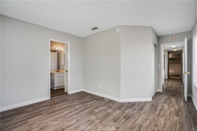 37940 42nd St E Unit 129, Palmdale, CA 93552 - spare room with wood finished floors and a textured ceiling