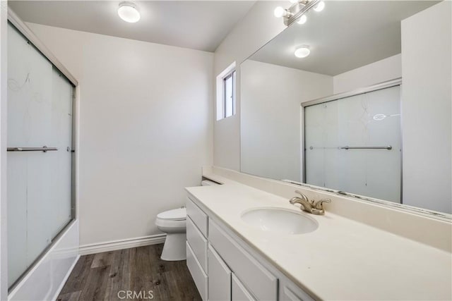 37940 42nd St E Unit 129, Palmdale, CA 93552 - bathroom with vanity, wood finished floors, and bath / shower combo with glass door