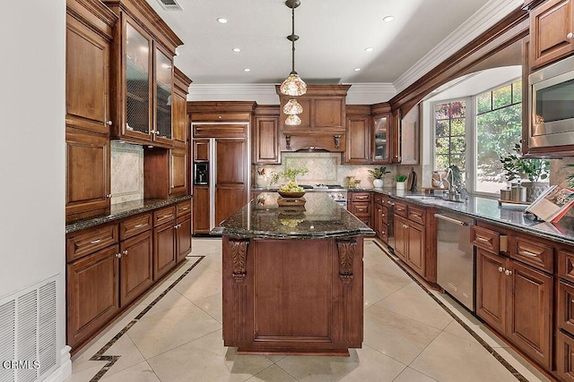 2981 Yucca Dr, Camarillo, CA 93012 - kitchen featuring built in appliances, a center island, ornamental molding, light tile patterned flooring, and backsplash