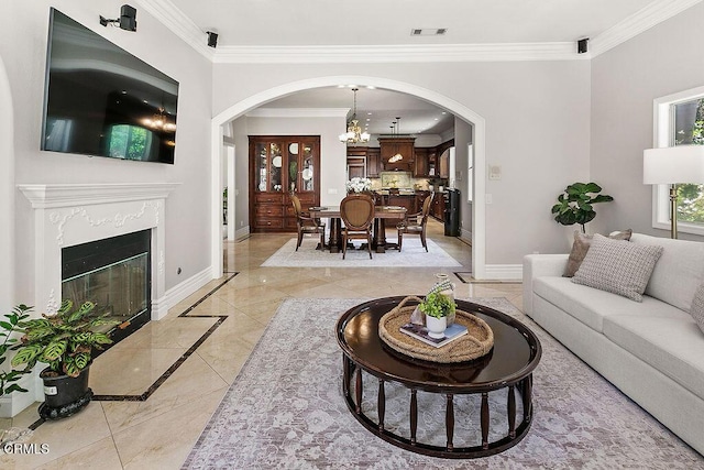 2981 Yucca Dr, Camarillo, CA 93012 - living room with arched walkways, inlaid floor details, ornamental molding, a chandelier, and a high end fireplace