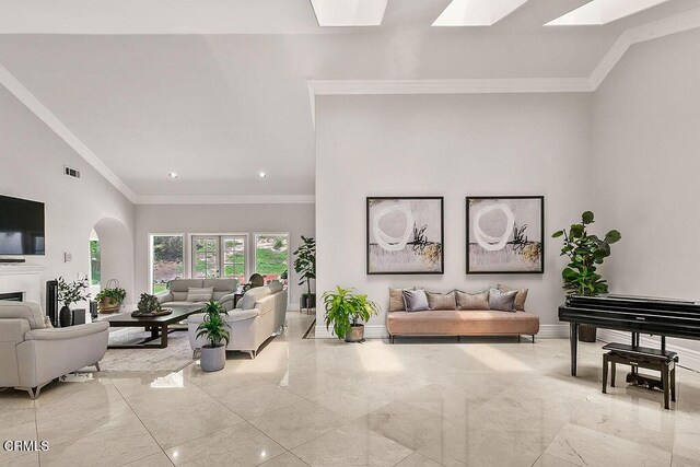 2981 Yucca Dr, Camarillo, CA 93012 - living room with arched walkways, a skylight, ornamental molding, light marble finish flooring, and recessed lighting