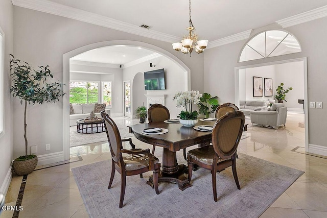 2981 Yucca Dr, Camarillo, CA 93012 - dining room featuring arched walkways, a chandelier, and crown molding