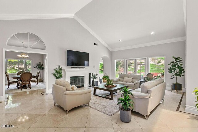 2981 Yucca Dr, Camarillo, CA 93012 - living area with plenty of natural light, arched walkways, a chandelier, a glass covered fireplace, and high vaulted ceiling
