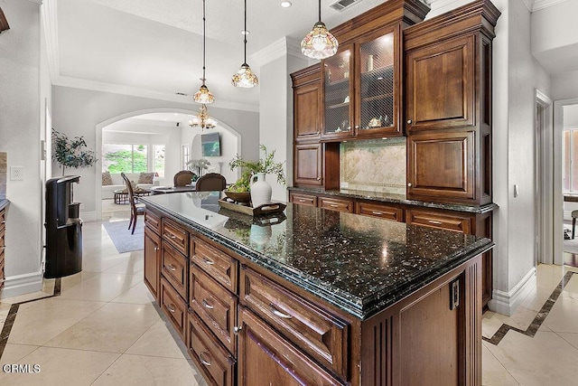2981 Yucca Dr, Camarillo, CA 93012 - kitchen featuring arched walkways, inlaid floor details, light tile patterned floors, tasteful backsplash, and crown molding